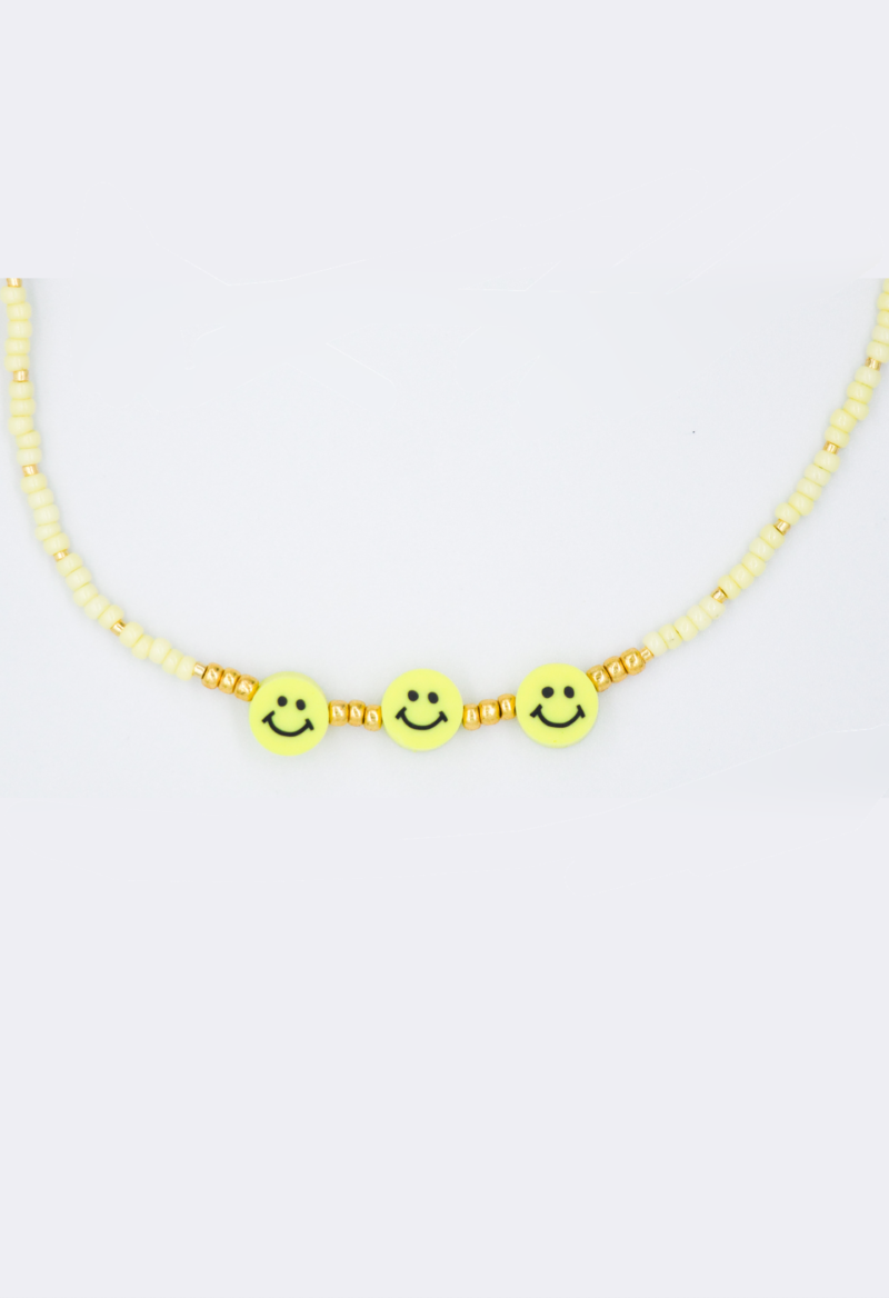 Gele kralen ketting met smileys en gouden details